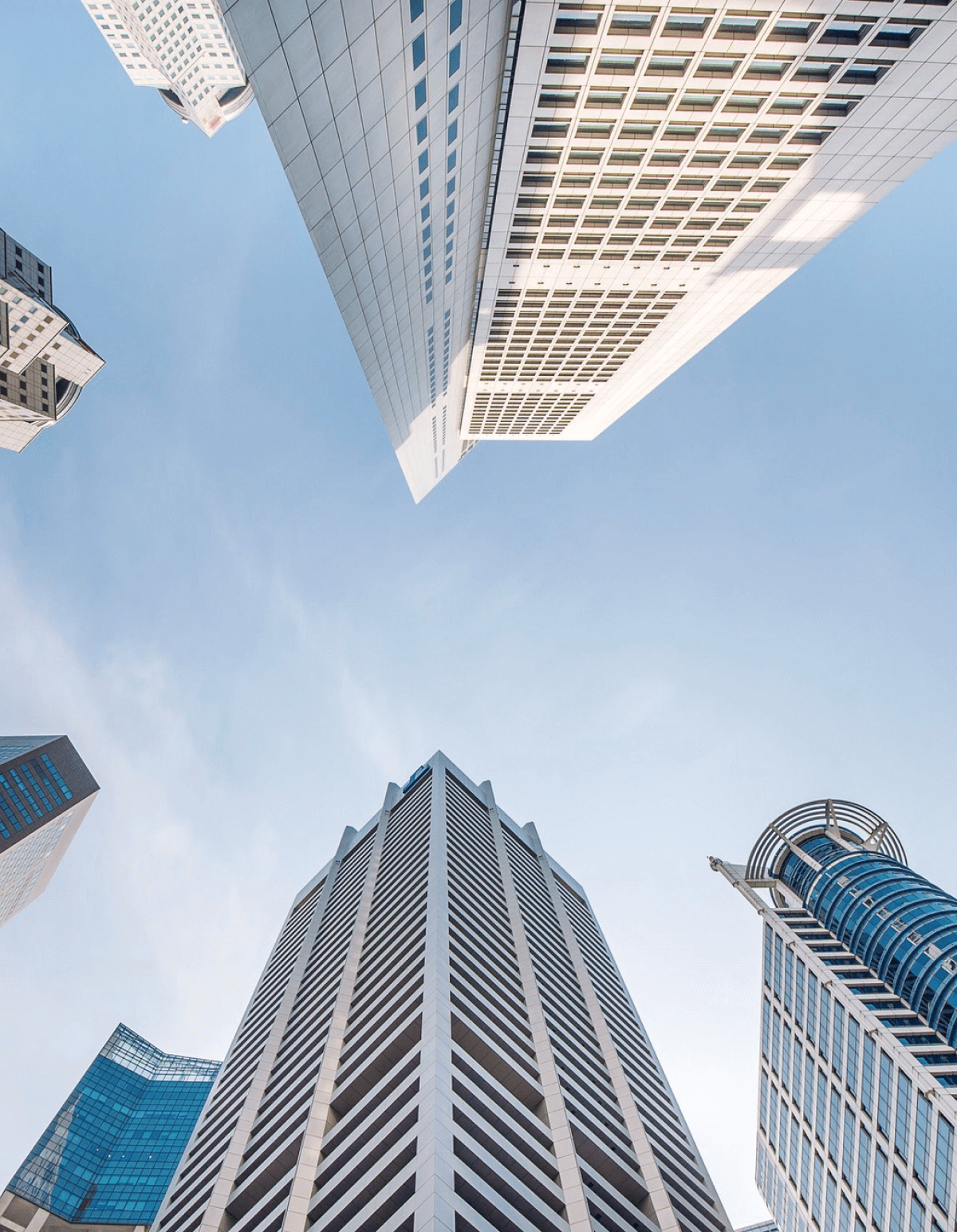 Modern skyscrapers viewed from low angle against blue sky